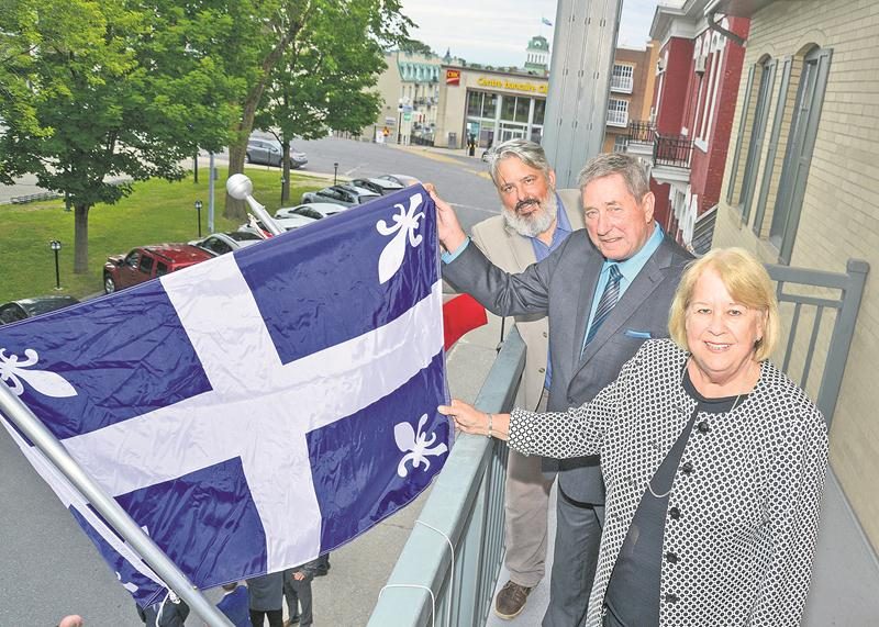 Le drapeau de Carillon, tenu ici par la préfet de la MRC des Maskoutains, Francine Morin, le maire de Saint-Jude, Yves de Bellefeuille, et Robert Mayrand, chargé de projet en patrimoine, a été déployé au siège administratif de la MRC en juillet 2017. Photothèque | Le Courrier ©
