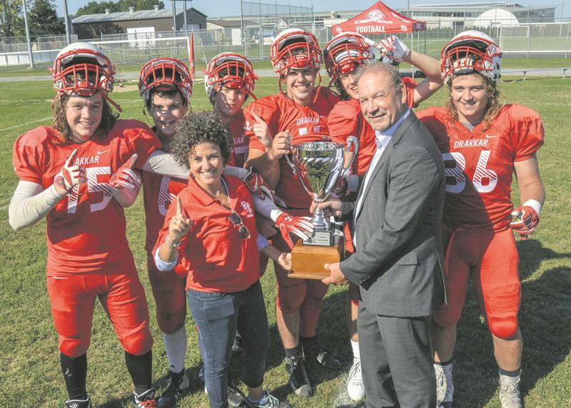 Après l’avoir échappée l’an dernier, le Drakkar a remporté la Coupe Groupe financier Multi Courtage de football de Saint-Hyacinthe devant les étudiants de la Polyvalente Hyacinthe-Delorme. La directrice de la PHD, Nancy Prévéreault, a reçu la coupe des mains de Guy Duhaime, président de Groupe financier Multi Courtage. Photo François Larivière | Le Courrier ©